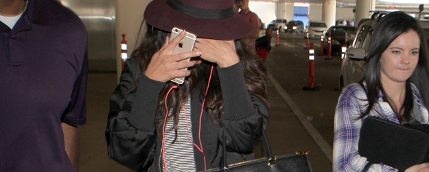 Selena Gomez camera shy at LAX